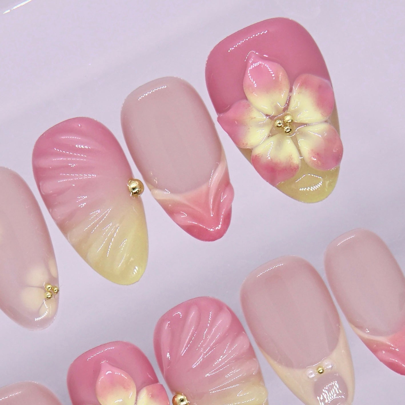 Light spring nail design with pink, yellow, and glossy finish