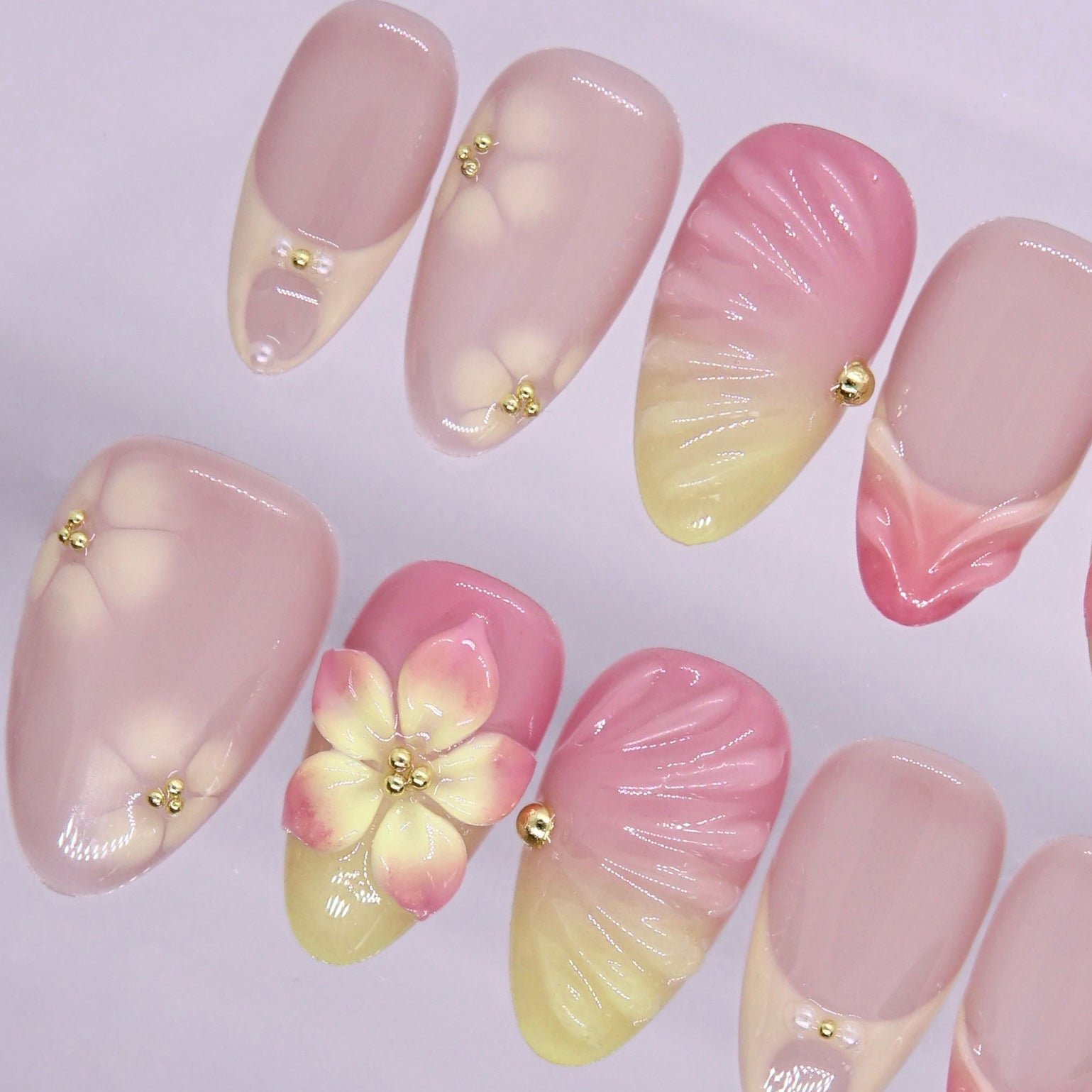 Light spring nail design with pink, yellow, and glossy finish